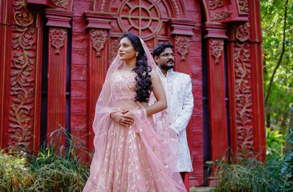 Bride in silk legnga and groom in sherwani posing
